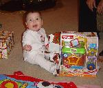 Opening her very first christmas gift